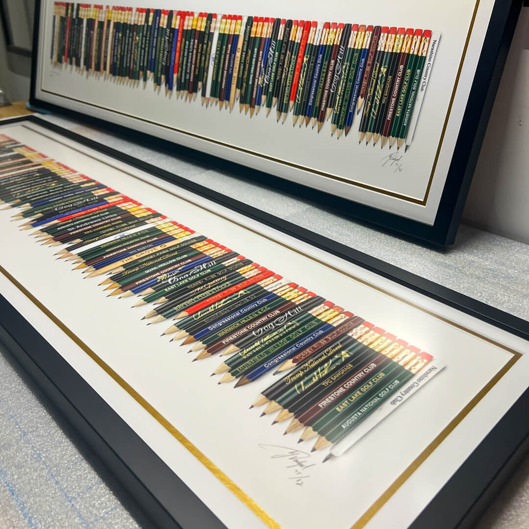 A framed golf art piece featuring a collection of golf pencils from all the 82 golf courses Tiger Woods won on the PGA TOUR. 