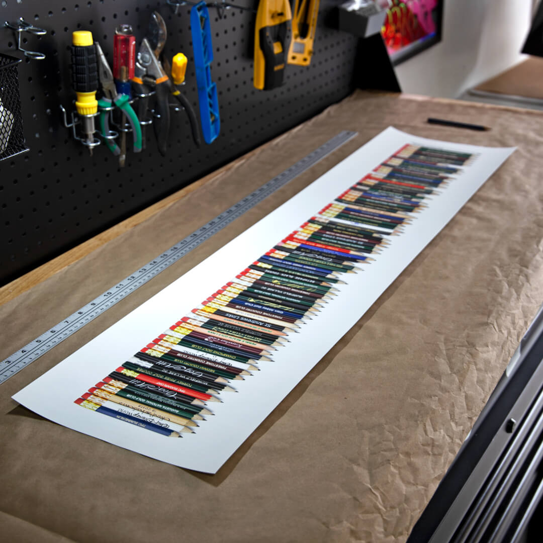A fine art golf art piece featuring a collection of golf pencils from all the 82 golf courses Tiger Woods won on the PGA TOUR. 